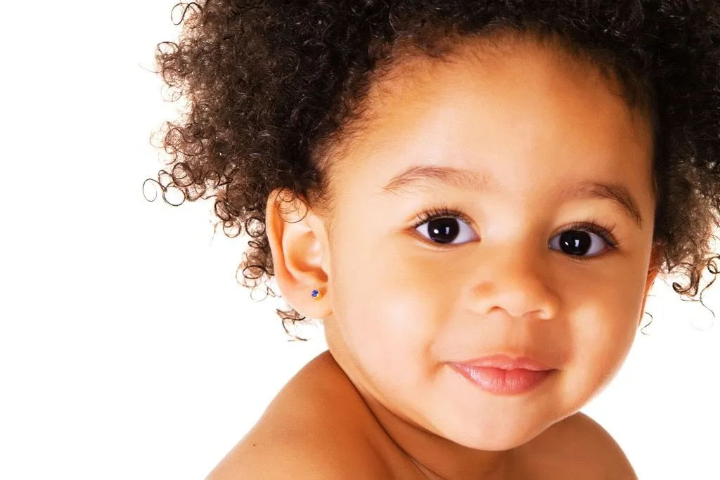 A smiling baby looking toward the camera